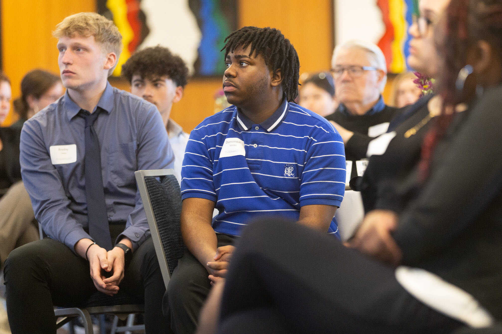 Students listen to an event.